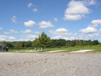 View of RV Pads with water and electric hook-ups. Note blue facilities on left adjacent to pavilion.